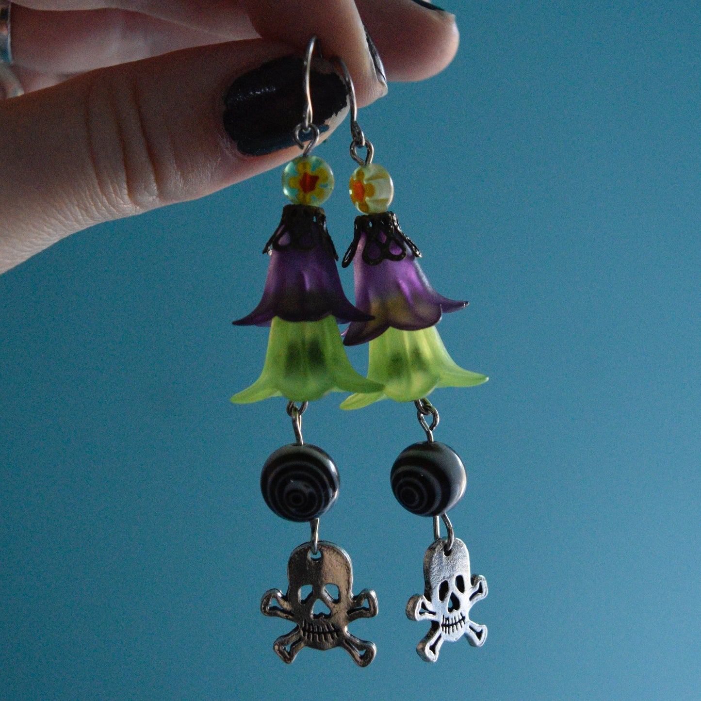 green/purple skull earrings